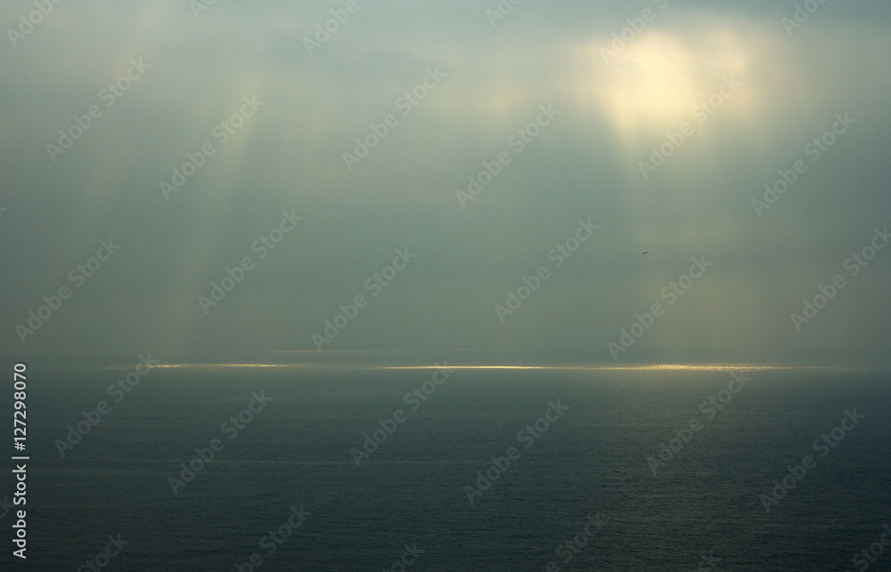 Sea horizon with ripples against grey sky at dusk bleakness over seascape background Sea horizon with ripples against grey sky at dusk bleakness over seascape background