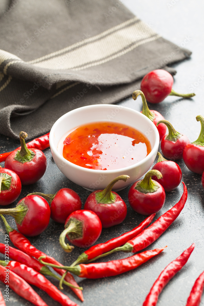 Red chili peppers and chili sauce. Red chili peppers and chili sauce.