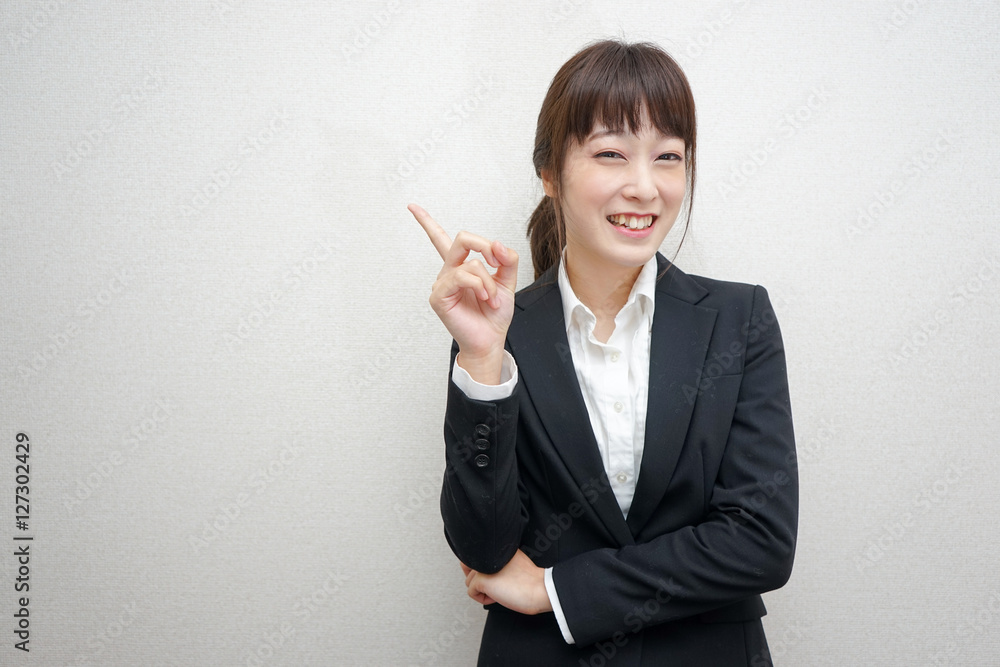 Young business woman pointing something with smile Young business woman pointing something with smile