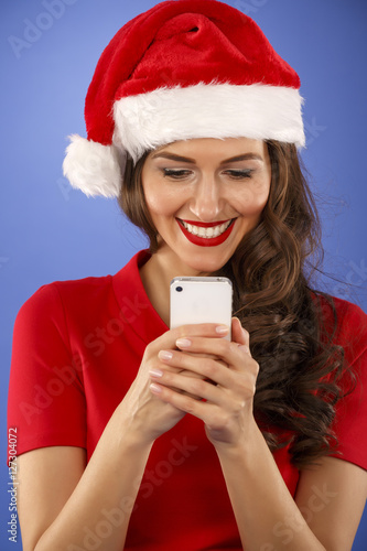 Christmas happy woman with a smart phone
