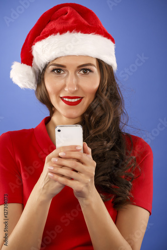 Christmas happy woman with a smart phone