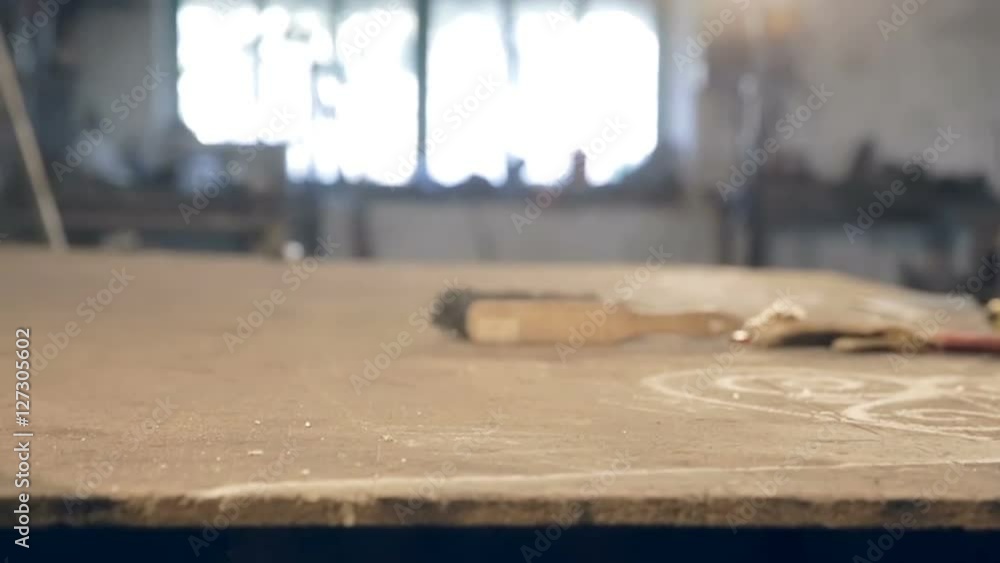Close-up man in apron blows dust from the table Close-up man in apron blows dust from the table