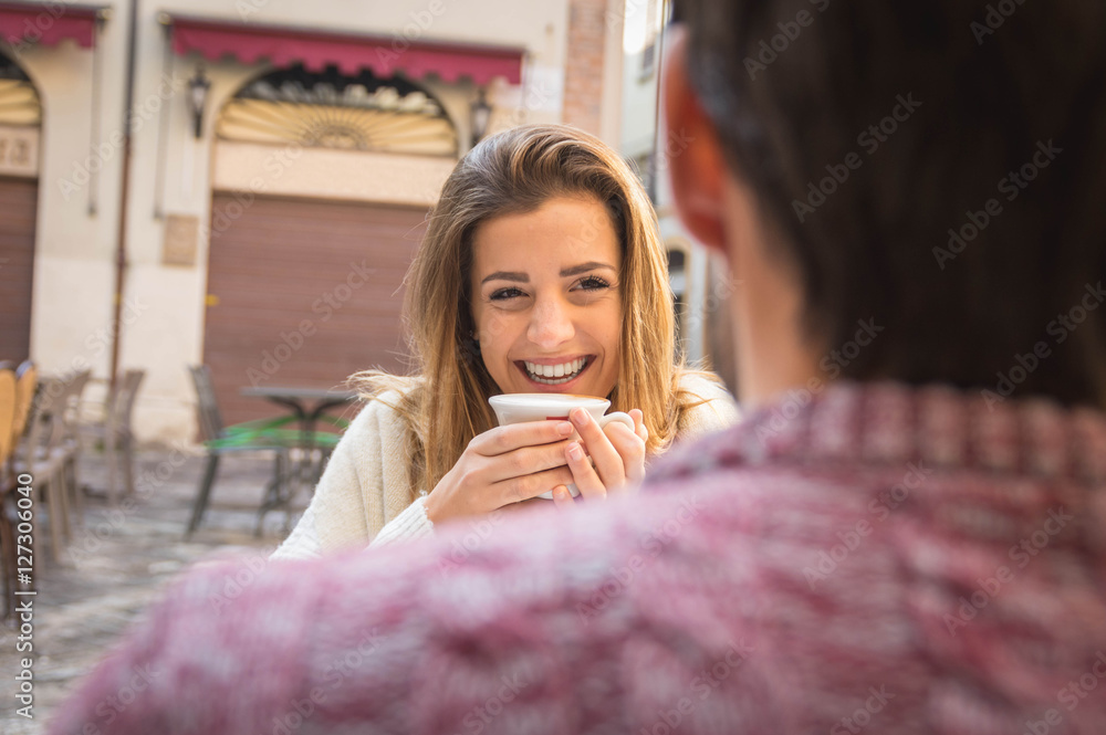 Portrait of young beautiful couple on a date drinking coffee in cafe Portrait of young beautiful couple on a date drinking coffee in cafe