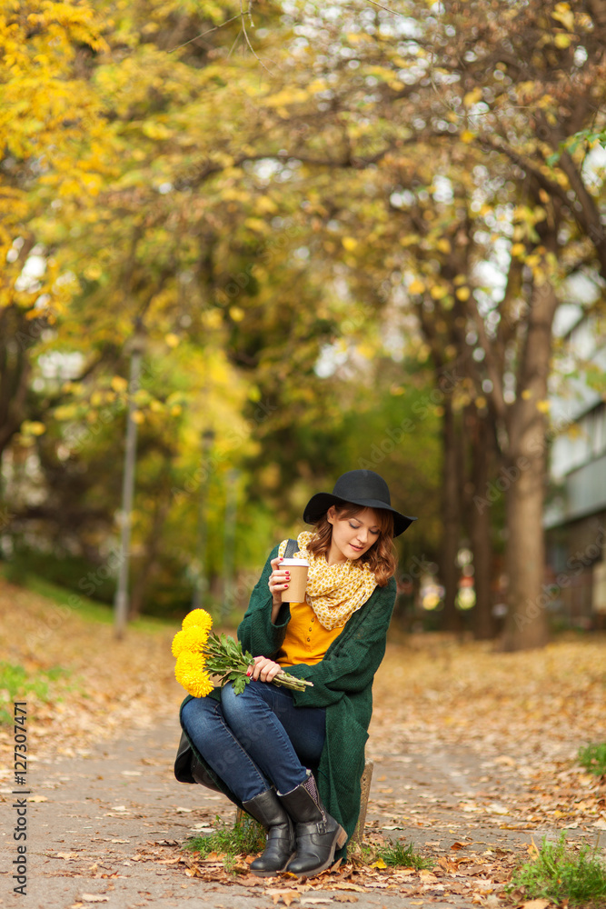 Young woman with bunch of yellow flowers Young woman with bunch of yellow flowers