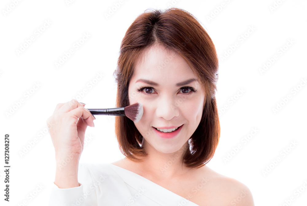 Closeup portrait of a woman applying dry cosmetic tonal foundation on the face using makeup brush.Beautiful woman with beauty face and perfect skin isolated on white background, asian model. Closeup portrait of a woman applying dry cosmetic tonal foundation on the face using makeup brush.Beautiful woman with beauty face and perfect skin isolated on white background, asian model.