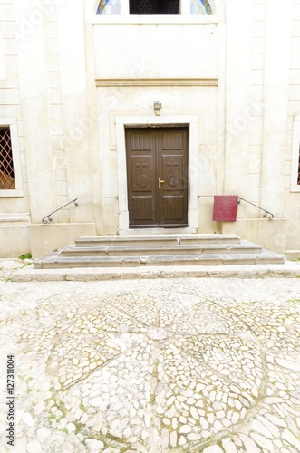 Vrbnik Wheel, Vrbnicko kolo, in front of the Church of the assumption on island of Krk, Croatia. Made of sea pebbles, a symbol for the creation of Glagolitic alphabet letters by Cyril.