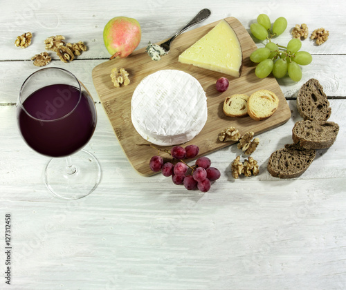 Red wine, cheese, grapes, nuts, with copyspace