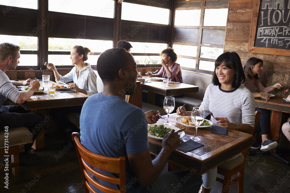 Mixed race couple enjoying lunch in a busy restaurant