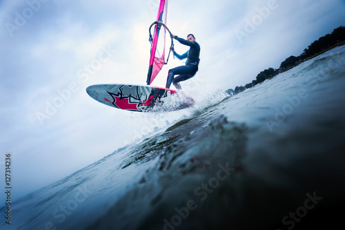 Windsurfer stunting on waves