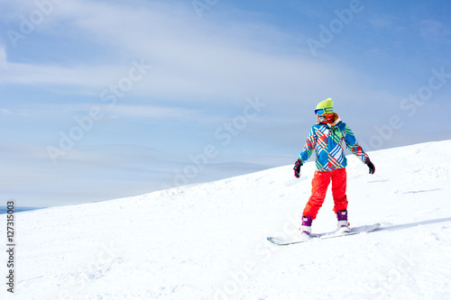 Female snowboarder on the slopes on a sunny morning