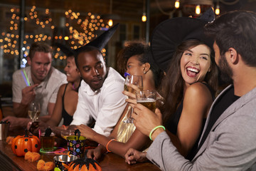 Friends having fun at a Halloween party in a bar