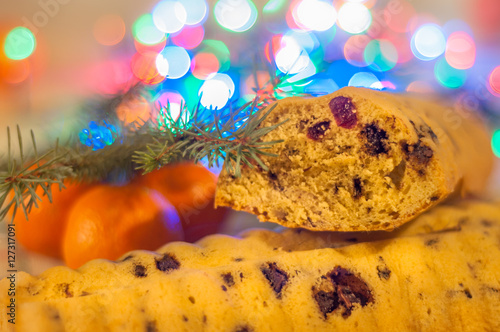 Christstollen ( Christmas Bread) with christmas lighst on the background photo