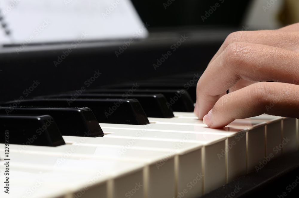 Fototapeta premium Child hands playing piano