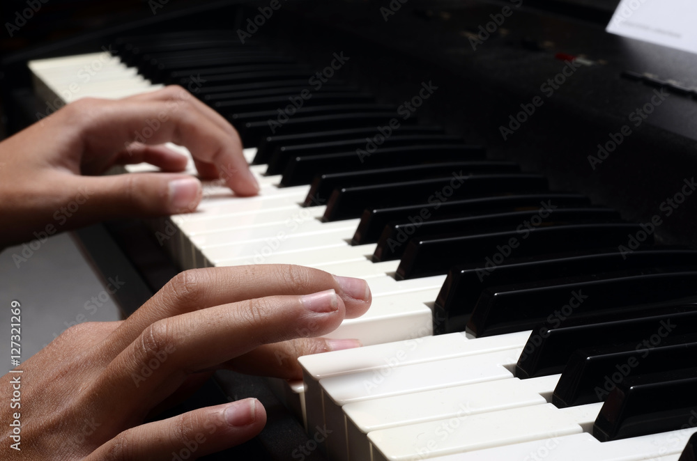Fototapeta premium Child hands playing piano