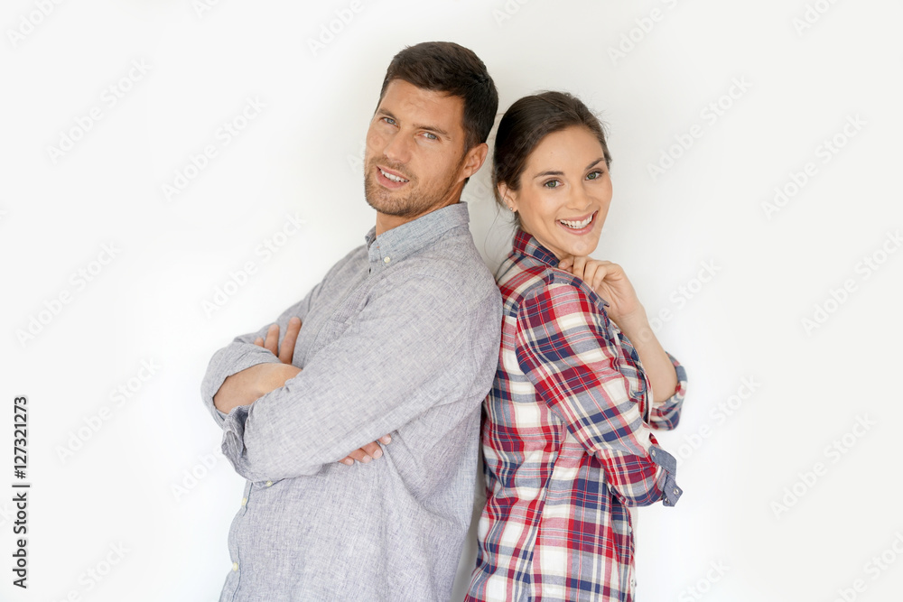 Cheerful 30-year-old couple standing on white background Cheerful 30-year-old couple standing on white background