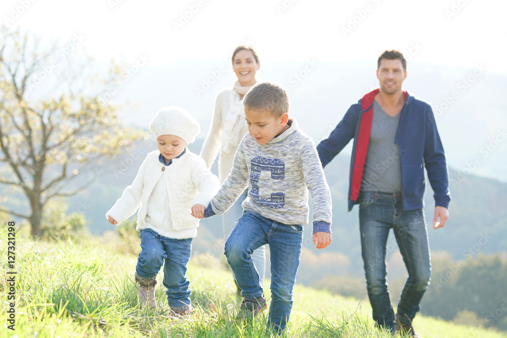 Happy family walking in countryside on autumnal week-end Happy family walking in countryside on autumnal week-end