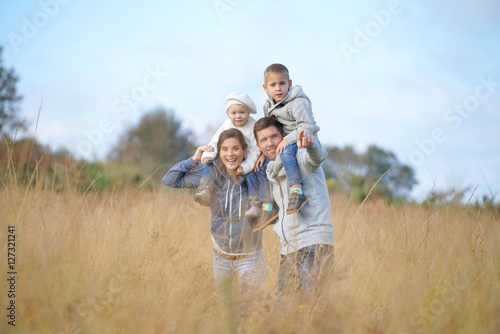 Happy family enjoying fall day in the countryside