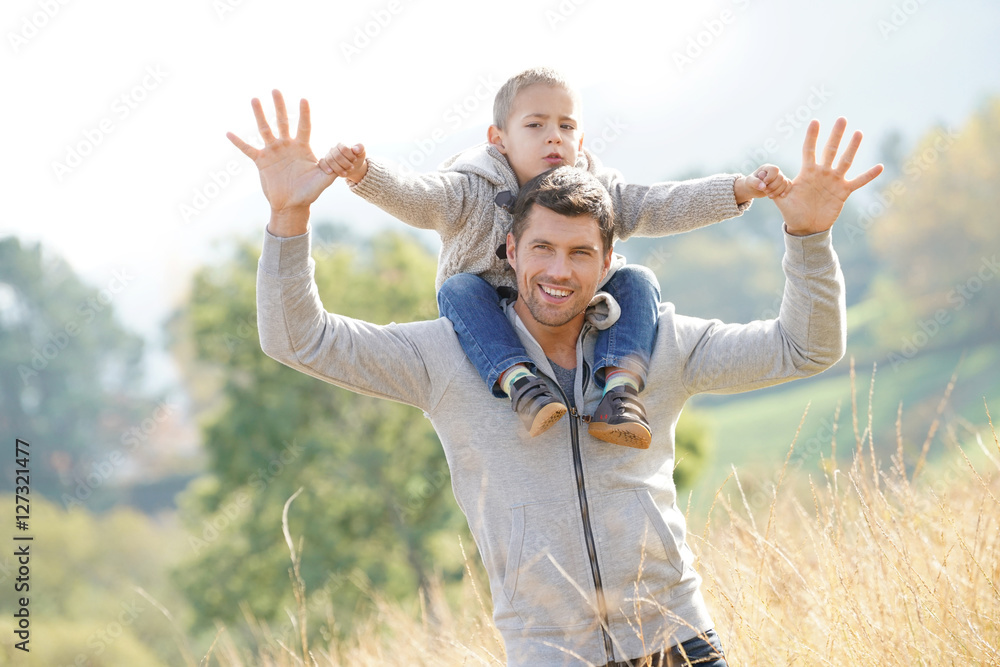 Daddy holding son on his shoulders out in the countryside Daddy holding son on his shoulders out in the countryside