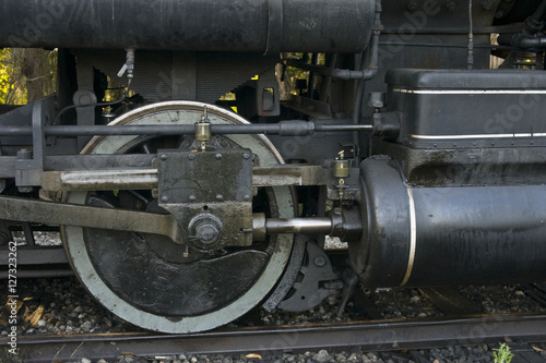 Close up of drive wheel and brake on a 1930s style steam locomotive, number 75 Flagg Coal steam engine.