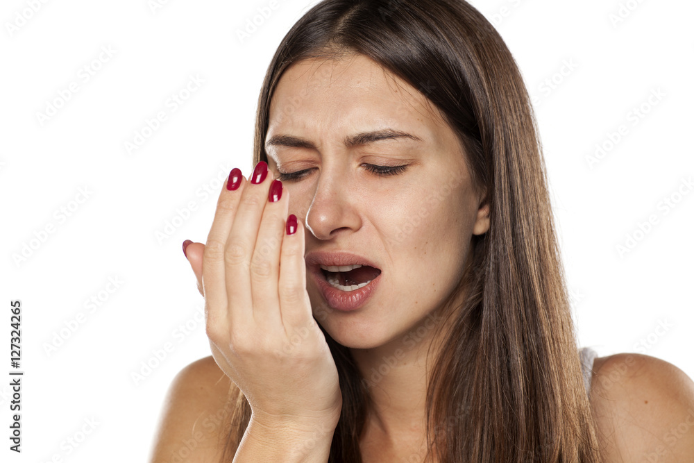 Fototapeta premium young woman check her breath with the palm