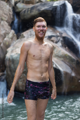 a man jumping off a cliff into the water