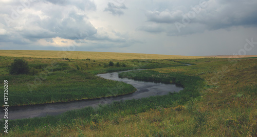 Cloudy summer landscape with river © valeriy boyarskiy