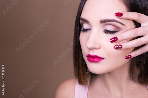 make up and manicure concept - portrait of beautiful woman and c