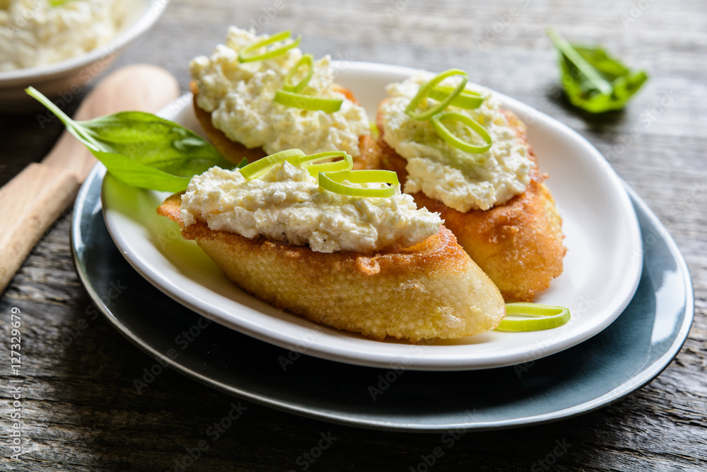 Horseradish and curd spread on fried egg baguette