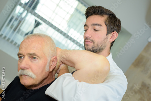 Therapist working on man's shoulder