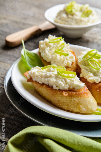 Horseradish and curd spread on fried egg baguette