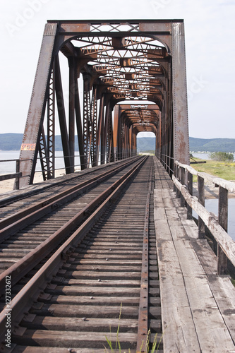 Iron and wooden railroad tressle bridge in Quebec, Canada.