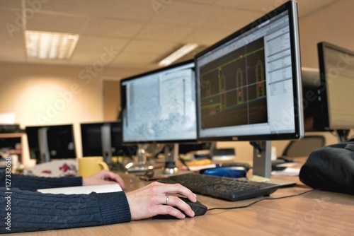 Woman's hand holding a mouse for office design work. Female arch photo