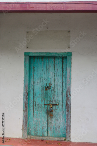 closed old blue wooden door. Mediterranean style exterior. © evolutionnow