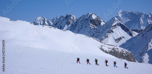 backcountry skiers in the Swiss Alps on a glacier near Disentis photo