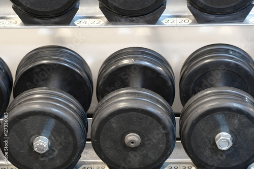 The image of dumbbells in a fitness hall