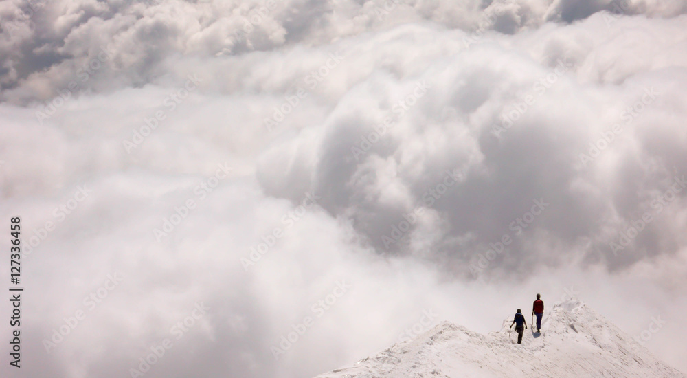 a mountain guide and client on an exposed ridge in the Swiss Alps before an oncoming storm