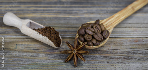 beautiful little wooden spoon with coffee on background