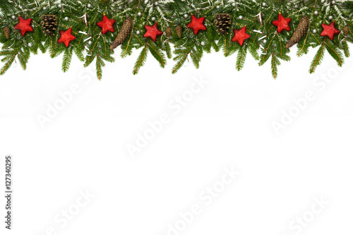 Christmas long decoration with red stars, cones and silver ribbons on artificial snow. White background.