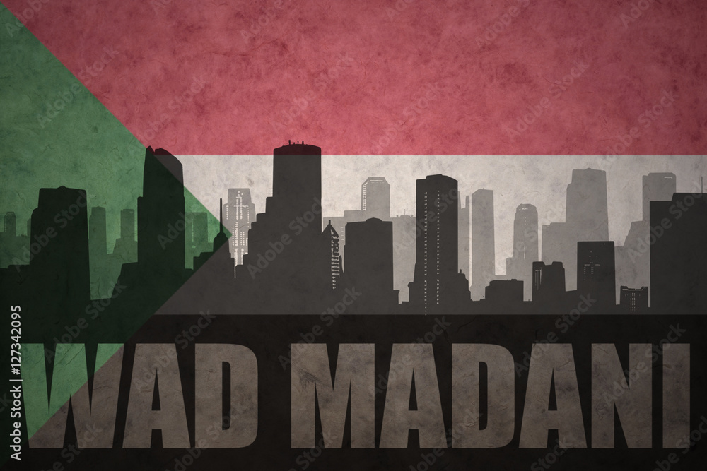 abstract silhouette of the city with text Wad Madani at the vintage sudanese flag