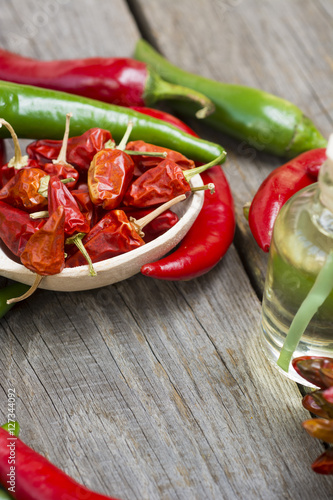 Fototapeta Naklejka Na Ścianę i Meble -  fresh red, yellow and green chilli on old wood background. selective focus image, space for advertising text  