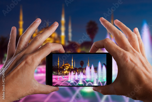 Travel concept. Hand making photo of city with smartphone camera. Istanbul. Turkey photo