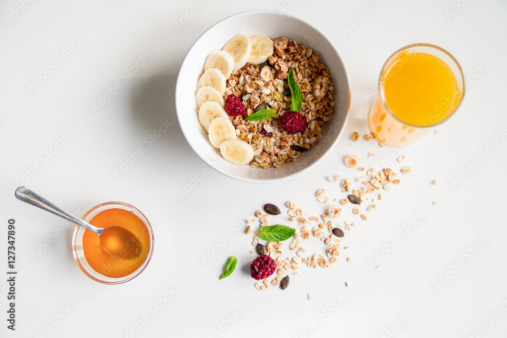 Breakfast with oatmeal and orange juice on white background Breakfast with oatmeal and orange juice on white background