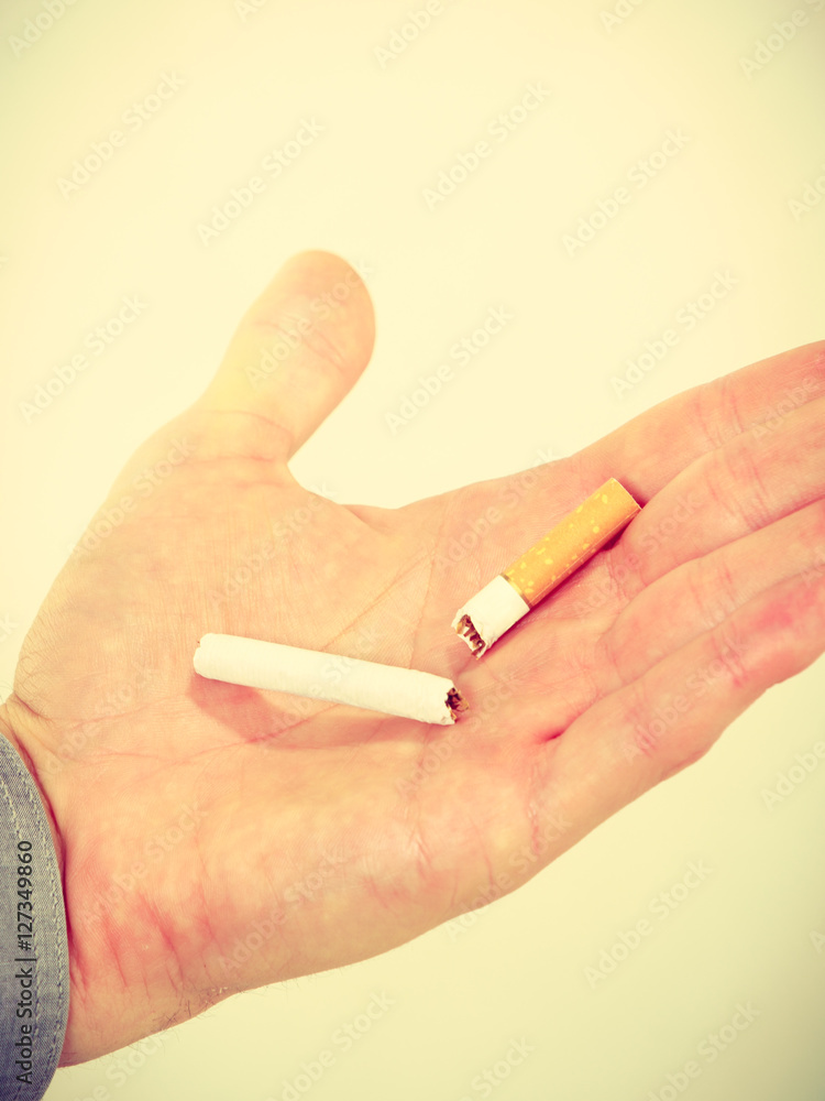 Closeup of broken cigarette on male hand. Closeup of broken cigarette on male hand.