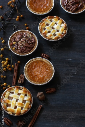 Top down view of 3 different pies - apple pie pumpkin pie and Pecan pie photo