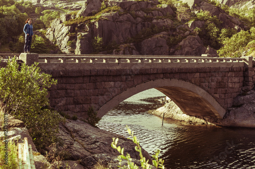 Female tourist on old bridge in Norway photo