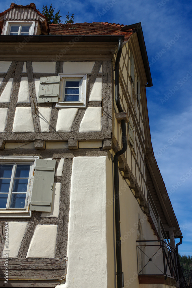 Residential tudor style house with blue sky in background