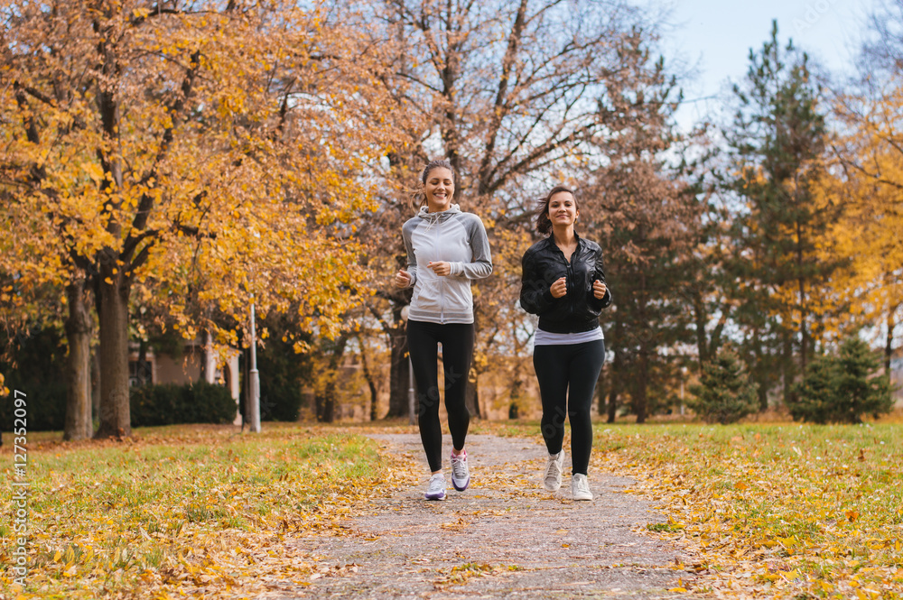 Obraz premium Beautiful girls Jogging Together outdoors