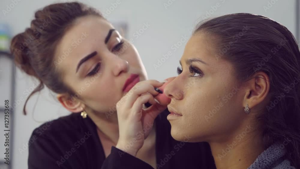 Makeup artist doing models makeup. Makeup artist doing models makeup.
