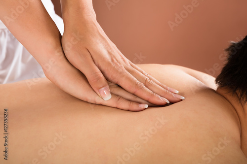 Fototapeta Naklejka Na Ścianę i Meble -  Close-up Of A Man Receiving Back Massage