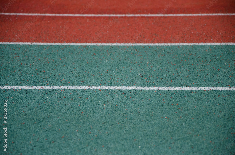 Closeup of running track with parallel white lines